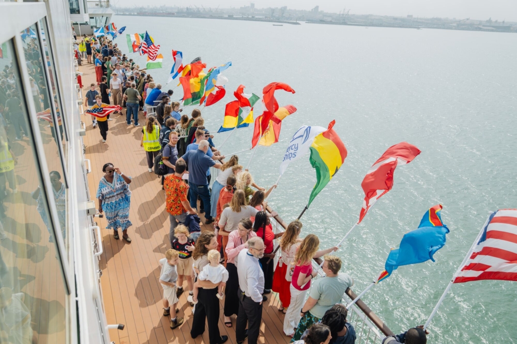 Flags wave on the Global Mercy as it nears Ghana